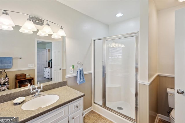 2507 Wateringhole Ct, Statesboro, GA 30458 - full bathroom featuring a stall shower, wainscoting, toilet, and vanity