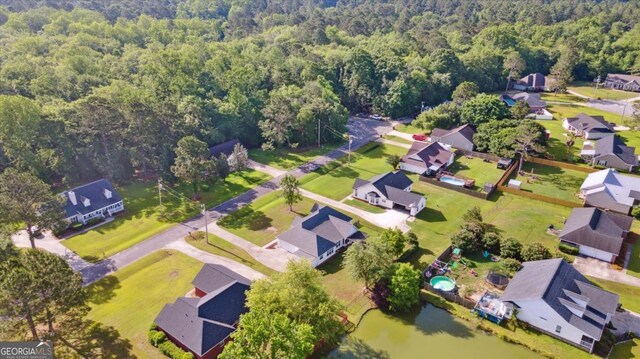 2507 Wateringhole Ct, Statesboro, GA 30458 - aerial view of property and surrounding area featuring a forest, nearby suburban area, and a large body of water