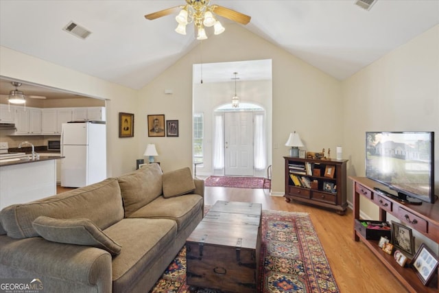 2507 Wateringhole Ct, Statesboro, GA 30458 - living room with ceiling fan, vaulted ceiling, and light wood finished floors