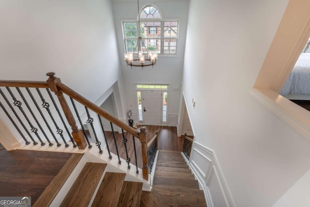 5281 Tormeall Trce, Suwanee, GA 30024 - stairs with a high ceiling, plenty of natural light, a chandelier, and wood finished floors