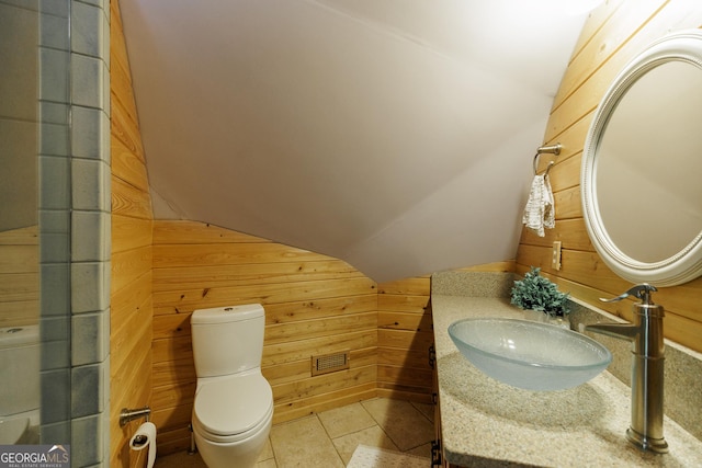 218 Wedgewood Dr, Danielsville, GA 30633 - bathroom featuring wood walls, vaulted ceiling, toilet, and vanity