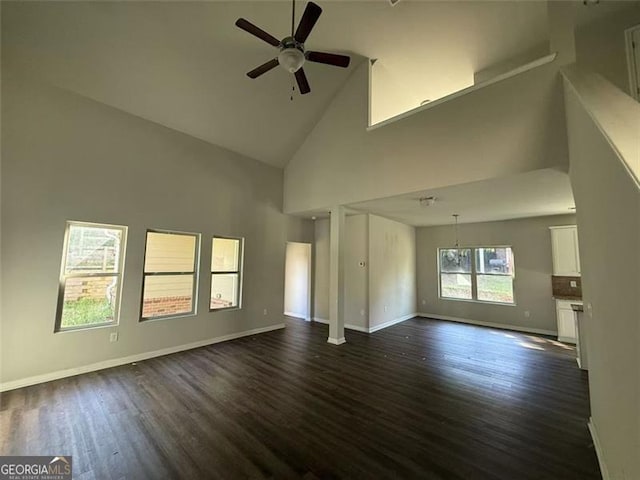 4287 Traipse Path, Ellenwood, GA 30294 - unfurnished living room featuring high vaulted ceiling, dark wood-style flooring, ceiling fan, and baseboards