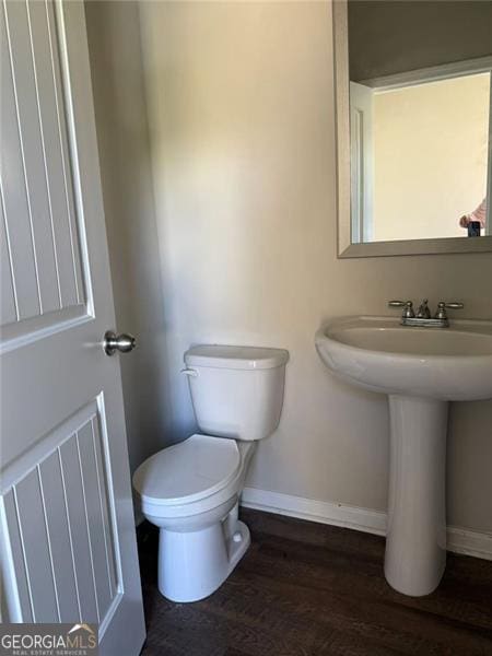 4287 Traipse Path, Ellenwood, GA 30294 - half bath featuring baseboards, wood finished floors, toilet, and a sink