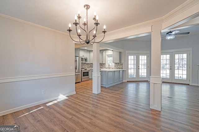 1443 Ebenezer Rd, Rincon, GA 31326 - unfurnished living room with french doors, crown molding, a chandelier, ceiling fan, and dark wood-style floors
