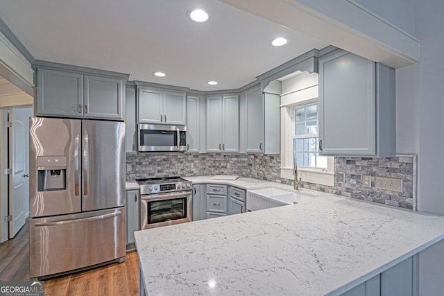 1443 Ebenezer Rd, Rincon, GA 31326 - kitchen featuring appliances with stainless steel finishes, gray cabinets, a sink, a peninsula, and recessed lighting
