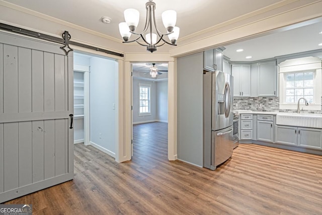 1443 Ebenezer Rd, Rincon, GA 31326 - kitchen with stainless steel fridge with ice dispenser, gray cabinets, crown molding, a chandelier, and backsplash