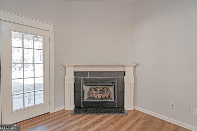1443 Ebenezer Rd, Rincon, GA 31326 - detailed view of baseboards, wood finished floors, and a tile fireplace