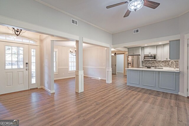 1443 Ebenezer Rd, Rincon, GA 31326 - kitchen with stainless steel appliances, gray cabinetry, a chandelier, open floor plan, and a sink