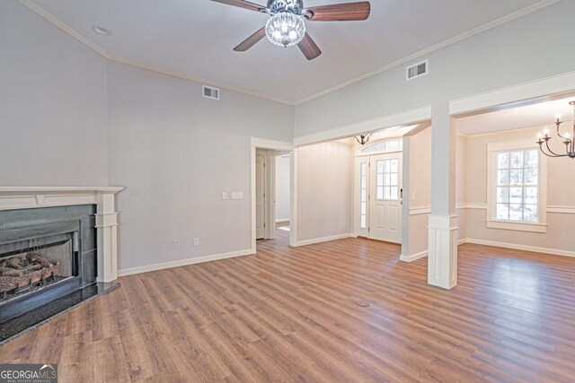 1443 Ebenezer Rd, Rincon, GA 31326 - unfurnished living room featuring a chandelier, ornamental molding, wood finished floors, a ceiling fan, and a fireplace with raised hearth