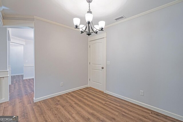 1443 Ebenezer Rd, Rincon, GA 31326 - spare room with a chandelier, wood finished floors, crown molding, and baseboards