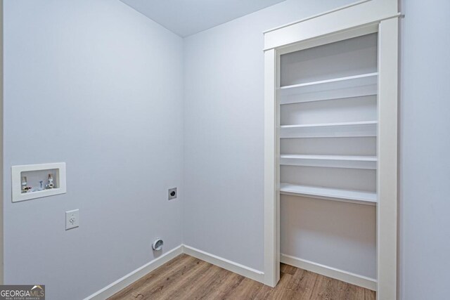 1443 Ebenezer Rd, Rincon, GA 31326 - clothes washing area with hookup for an electric dryer, wood finished floors, washer hookup, and baseboards