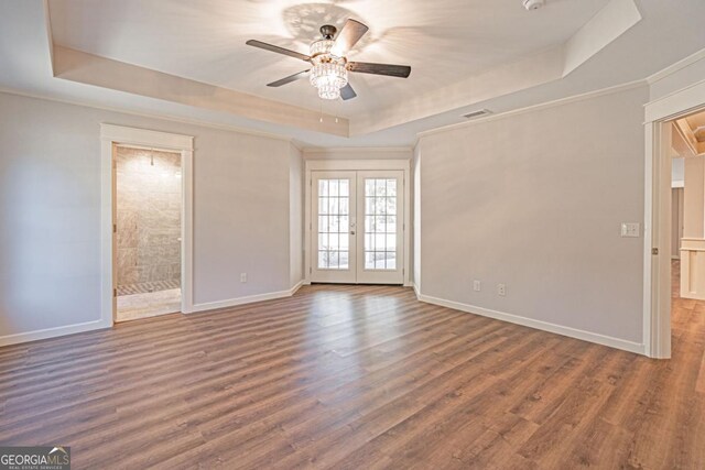 1443 Ebenezer Rd, Rincon, GA 31326 - empty room featuring a tray ceiling, french doors, ceiling fan, baseboards, and crown molding