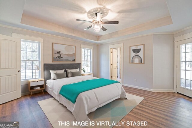 1443 Ebenezer Rd, Rincon, GA 31326 - bedroom with a raised ceiling, multiple windows, wood finished floors, baseboards, and crown molding
