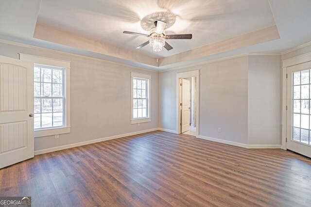 1443 Ebenezer Rd, Rincon, GA 31326 - unfurnished room with a tray ceiling, ceiling fan, wood finished floors, plenty of natural light, and crown molding