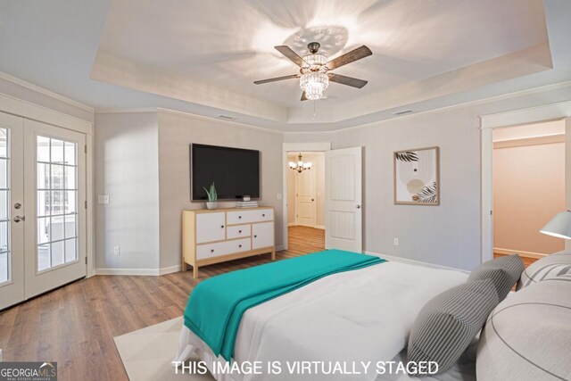 1443 Ebenezer Rd, Rincon, GA 31326 - bedroom featuring a raised ceiling, wood finished floors, baseboards, french doors, and a chandelier