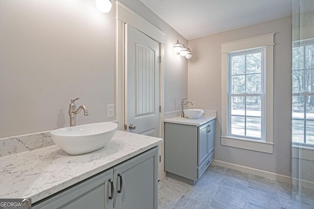 1443 Ebenezer Rd, Rincon, GA 31326 - bathroom with two vanities, plenty of natural light, and baseboards
