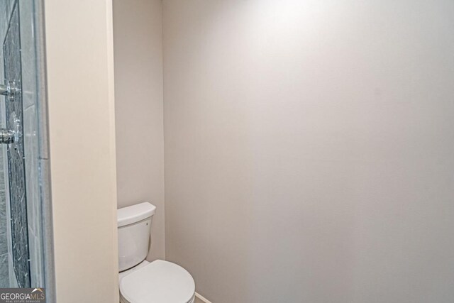 1443 Ebenezer Rd, Rincon, GA 31326 - bathroom featuring toilet and baseboards