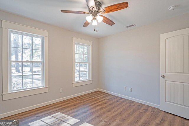 1443 Ebenezer Rd, Rincon, GA 31326 - spare room featuring wood finished floors, baseboards, a smoke detector, and a ceiling fan