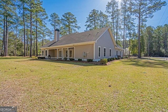 1443 Ebenezer Rd, Rincon, GA 31326 - rear view of house with a chimney and a yard