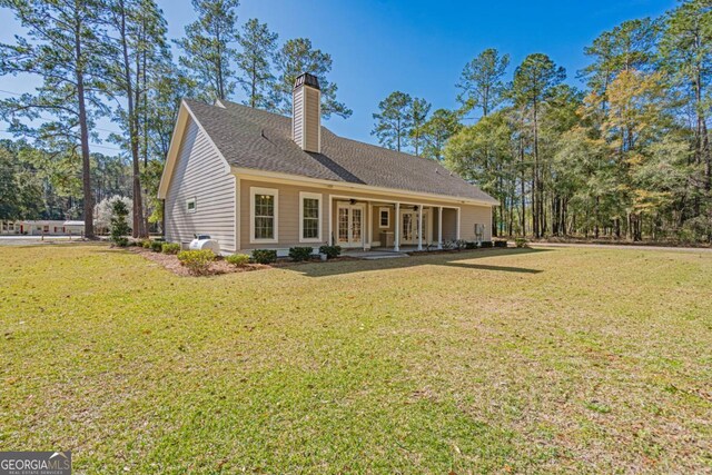 1443 Ebenezer Rd, Rincon, GA 31326 - rear view of property featuring a yard, a chimney, french doors, and roof with shingles