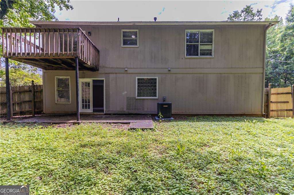 5339 Biffle Downs Rd, Stone Mountain, GA 30088 - rear view of property featuring central AC unit and a wooden deck
