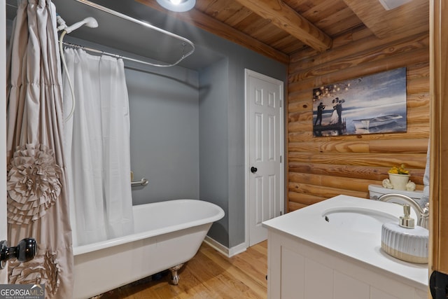bathroom featuring wooden ceiling, a freestanding bath, wood finished floors, rustic walls, and curtained shower
