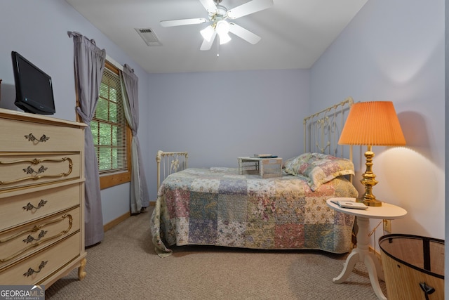 bedroom with light carpet and a ceiling fan