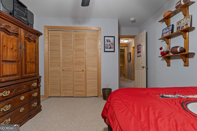 bedroom with light carpet, a closet, and a ceiling fan