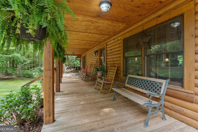 wooden terrace featuring covered porch