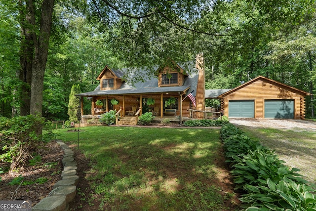 log-style house featuring log siding, a porch, a chimney, dirt driveway, and a front lawn