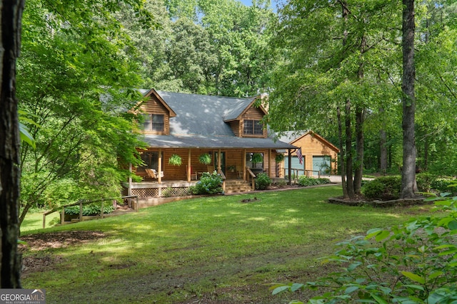 view of front of house featuring covered porch, a garage, a chimney, and a front lawn
