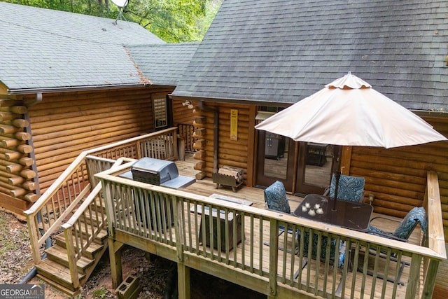 wooden terrace featuring outdoor dining area