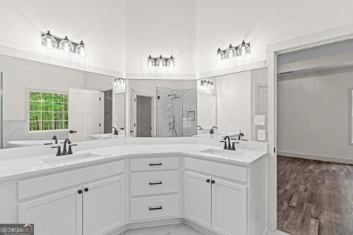 full bath with a stall shower and double vanity