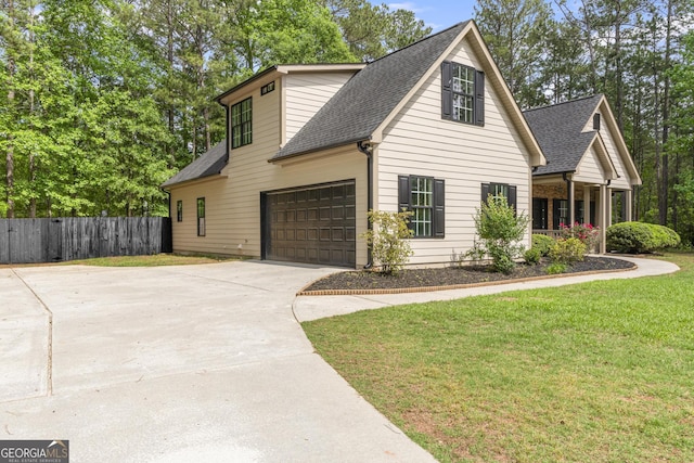 view of front facade with roof with shingles, driveway, and a garage