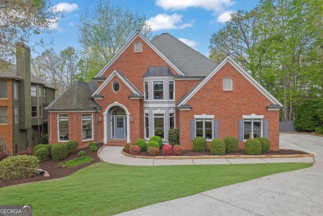 1025 Saint Marks Walk, Suwanee, GA 30024 - view of front of house with brick siding, a front lawn, and roof with shingles