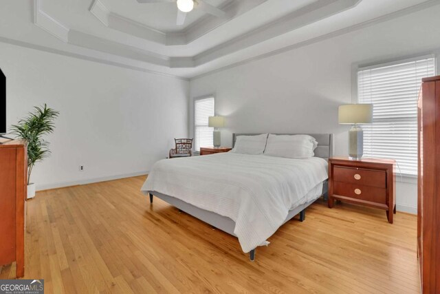 1025 Saint Marks Walk, Suwanee, GA 30024 - bedroom with a raised ceiling, crown molding, light wood-style flooring, ceiling fan, and baseboards
