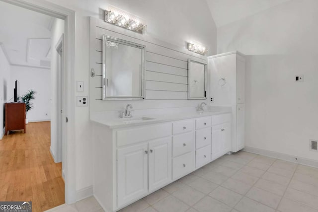 1025 Saint Marks Walk, Suwanee, GA 30024 - bathroom with vaulted ceiling, double vanity, and baseboards