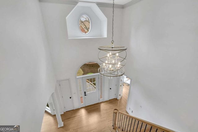 1025 Saint Marks Walk, Suwanee, GA 30024 - entryway featuring a chandelier, a towering ceiling, wood finished floors, baseboards, and healthy amount of natural light