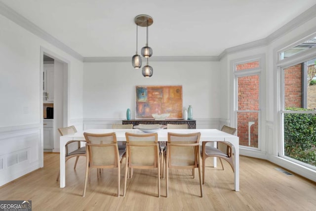 1025 Saint Marks Walk, Suwanee, GA 30024 - dining space with crown molding, light wood-type flooring, and a wainscoted wall