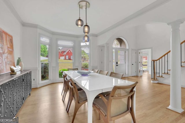 1025 Saint Marks Walk, Suwanee, GA 30024 - dining room featuring decorative columns, light wood finished floors, stairs, and crown molding