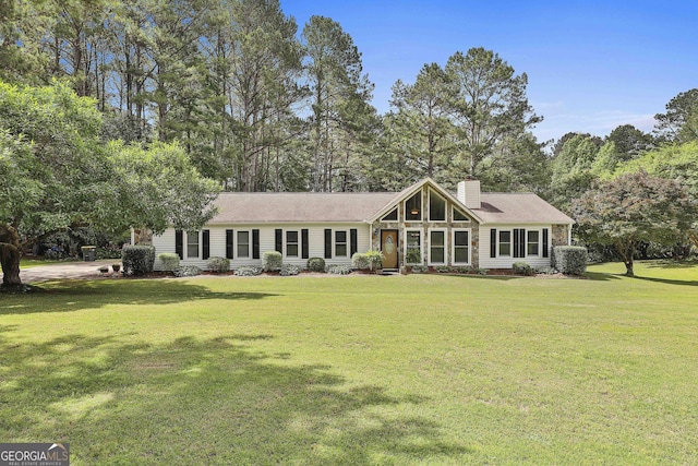 view of front of house with a chimney and a front lawn