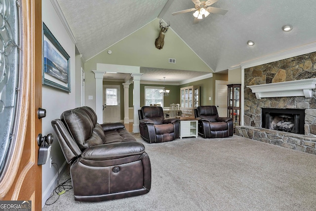 carpeted living area with ornate columns, ornamental molding, a textured ceiling, a ceiling fan, and baseboards