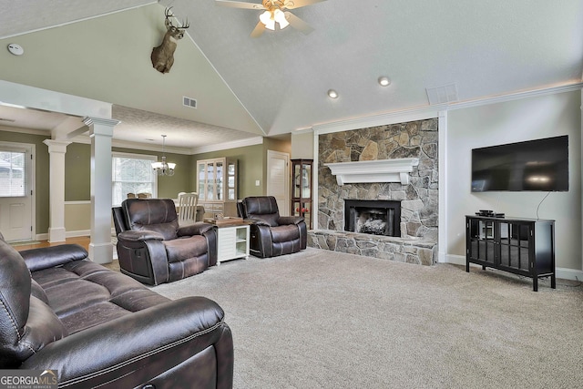 carpeted living room featuring ornamental molding, a ceiling fan, a chandelier, lofted ceiling, and a stone fireplace