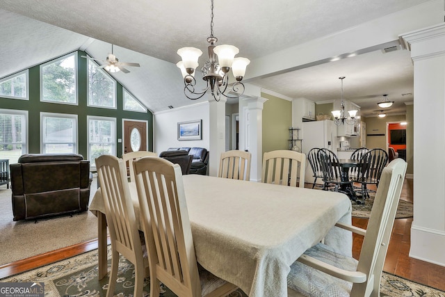 dining room with a chandelier, wood finished floors, ceiling fan, vaulted ceiling, and baseboards