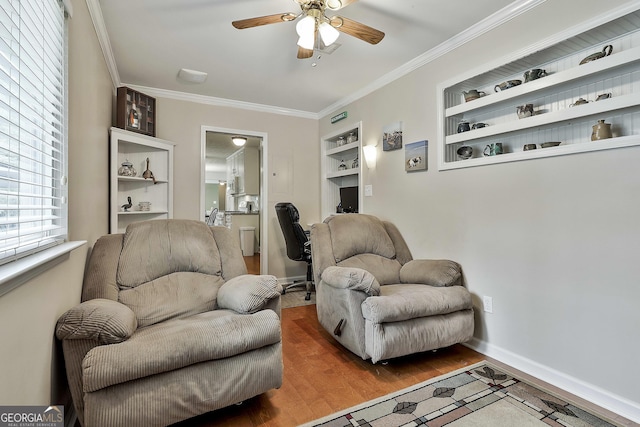 living room featuring a ceiling fan, crown molding, wood finished floors, built in features, and baseboards