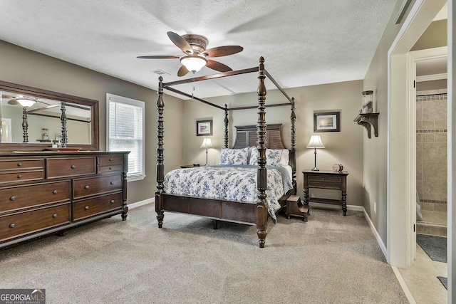 bedroom featuring baseboards, light colored carpet, ceiling fan, and a textured ceiling
