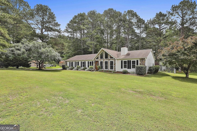 view of front of house with a front lawn and a chimney