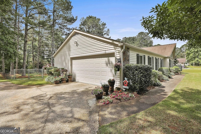 view of home's exterior with driveway and an attached garage