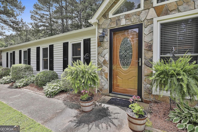 entrance to property featuring stone siding
