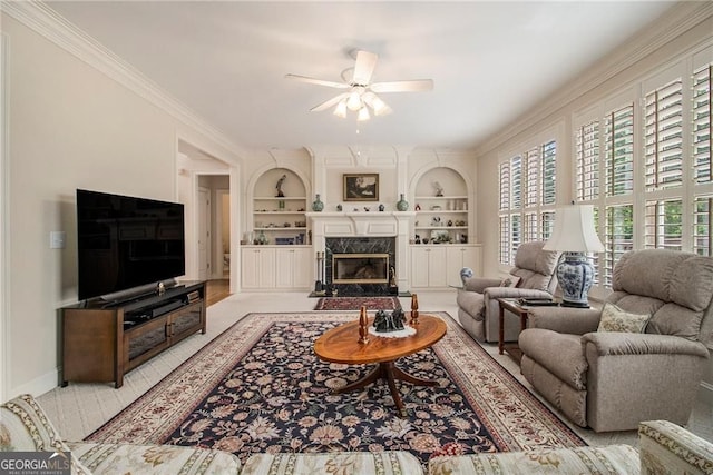 4045 Bonnett Creek Ln, Hoschton, GA 30548 - living room featuring ceiling fan, crown molding, built in features, a premium fireplace, and baseboards